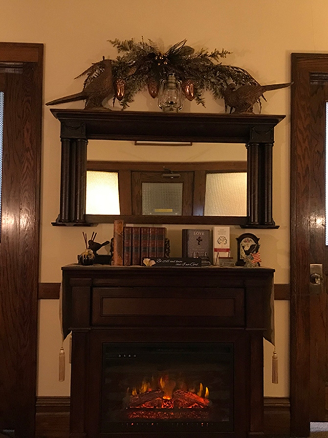 Office interior with a fireplace and mirror